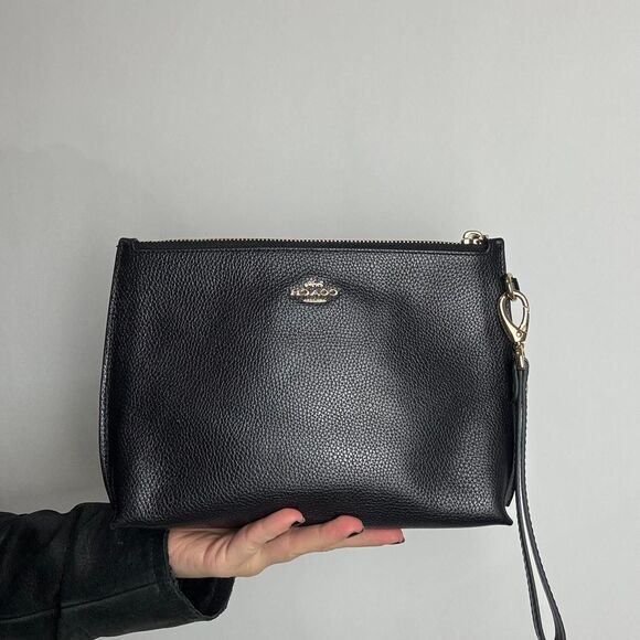 Coach Handbags - Coach black leather pouch bag with gold hardware